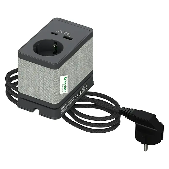 Schneider Electric New Unica Enchufe con USB de escritorio - Antracita, 3,1 A - Imagen de un cubo de toma de corriente Schneider Electric con cubierta de tela, puertos USB y un cable de alimentación trenzado grueso.
