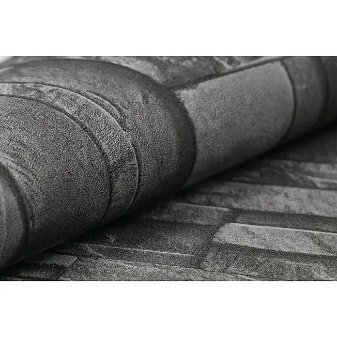 Rasch Vliestapete Steinoptik - Grau, 3D-Optik, 10,4 x 0,53 m - Nahaufnahme einer grauen Steinmauer-Tapetenrolle, die eine realistische Textur und ein modernes Design zeigt.