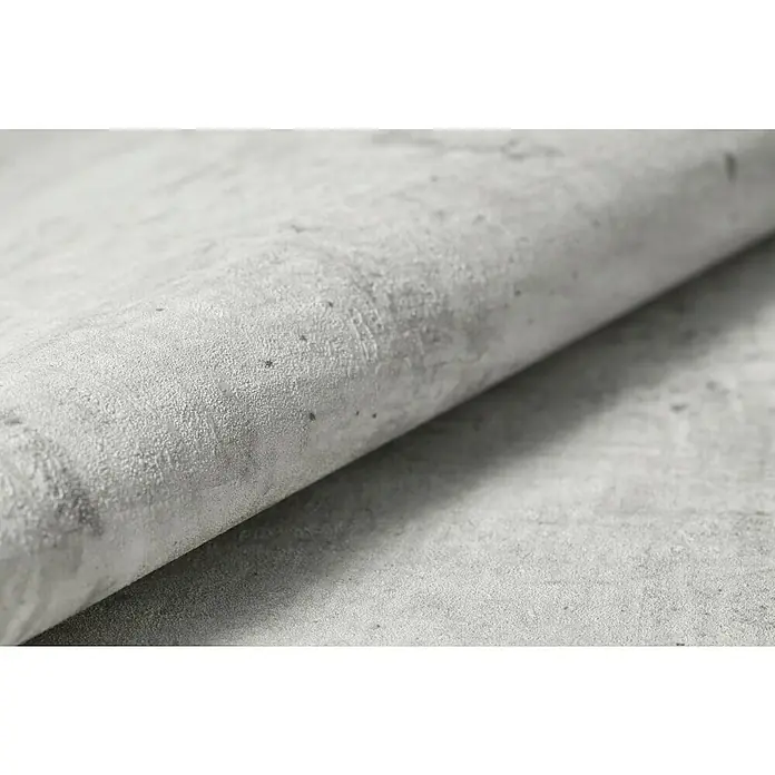 Rasch Tapetenwechsel Vliestapete - Grau, Betonoptik, 10,05 x 0,53 m - Nahaufnahme eines hellgrauen, strukturierten Untergrunds, der sich aufrollt und eine interessante Textur und Farbschattierungen zeigt.