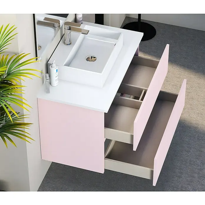 Artysan Mueble bajo de lavabo Fons - 46 x 60 x 56 cm, Rosa - Un moderno mueble de baño rosa con cajones abiertos y un lavabo de encimera blanco, perfecto para un baño elegante.