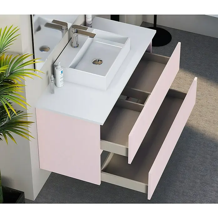 Artysan Mueble bajo de lavabo Fons - 46 x 90 x 56 cm, Rosa - Tocador de baño moderno con superficies blancas, gabinetes rosados y dos cajones abiertos para almacenamiento adicional.