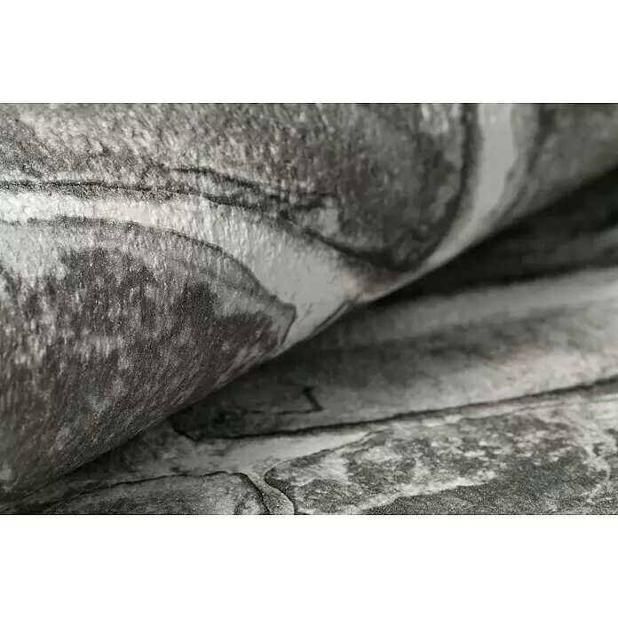 Rasch Papiertapete - Grau, Steinoptik, 10,05 x 0,53 m - Graue strukturierte Tapete mit Steinmuster, sanft gebogen dargestellt.