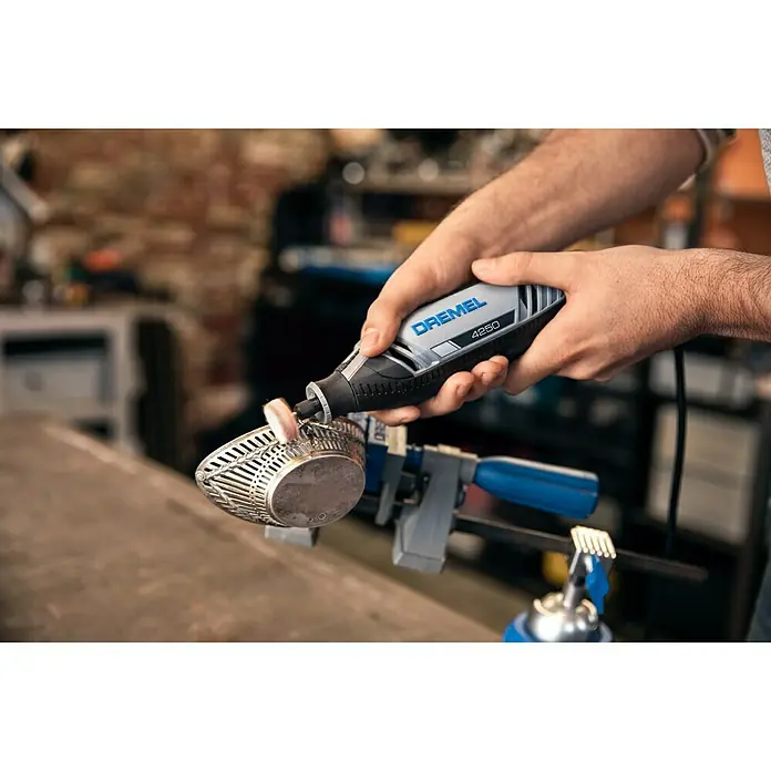 Dremel Herramienta rotativa eléctrica 4250-35 - 175 W, 5.000 r.p.m. - 35.000 r.p.m., 35 accesorios - Herramienta rotativa Dremel 4250 en acción, ideal para esmerilar y pulir metales en el taller.