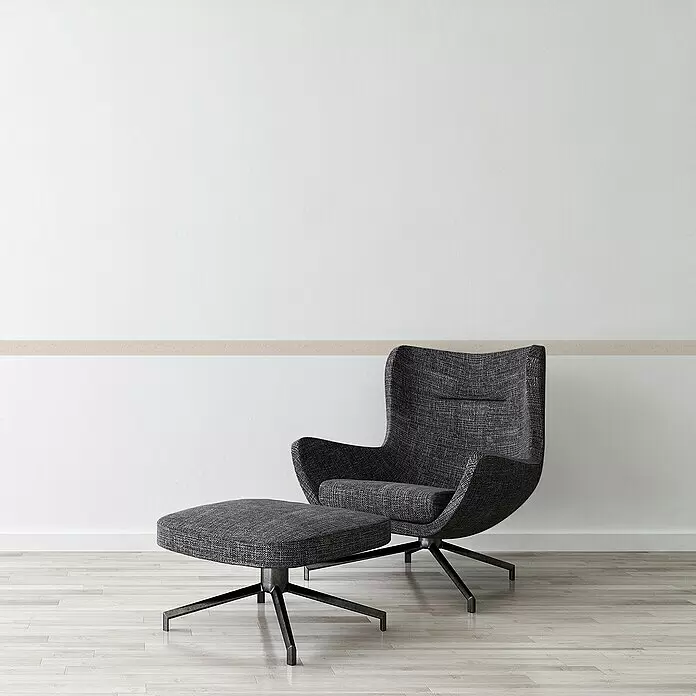 A.S. Création Only Borders 11 Tapetenborte Blattranke - Kunststoff, Creme - Moderner dunkelgrauer Sessel und passender Hocker mit schwarzen Sternfüßen in einem minimalistischen Raum.