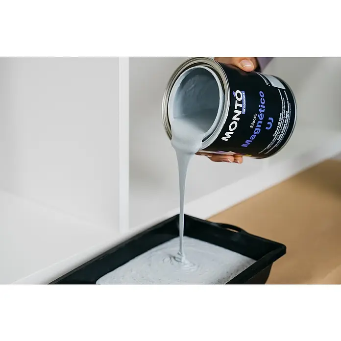 Montó Bricolovers Pintura magnética - Gris, 750 ml - Pintura magnética gris de la marca Montó vertiéndose de una lata a una bandeja negra. Este producto es ideal para diseños de pared creativos.