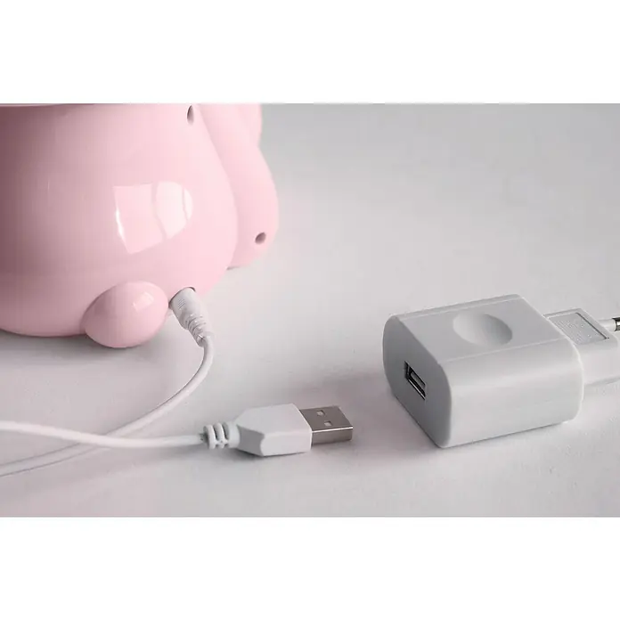 Idp Lampshades Lámpara de sobremesa LED Bunny - 3 W, Ø x Al: 19,5 x 30 cm, Rosa - Primer plano de un dispositivo rosa con un cable de carga blanco conectado a un adaptador de corriente blanco.