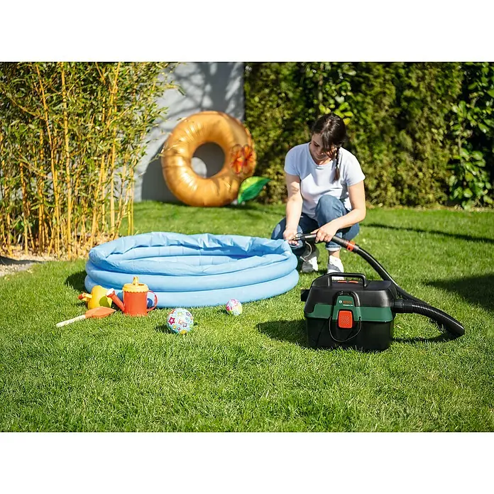 Bosch Power for All 18V Akku-Nass-Trockensauger AdvancedVac 18V-8 - 18 V, Ohne Akku, Behältervolumen: 8 l - Eine Frau pumpt ein Planschbecken mit einem schwarzen und grünen Bosch-Inflator in einem Garten auf.