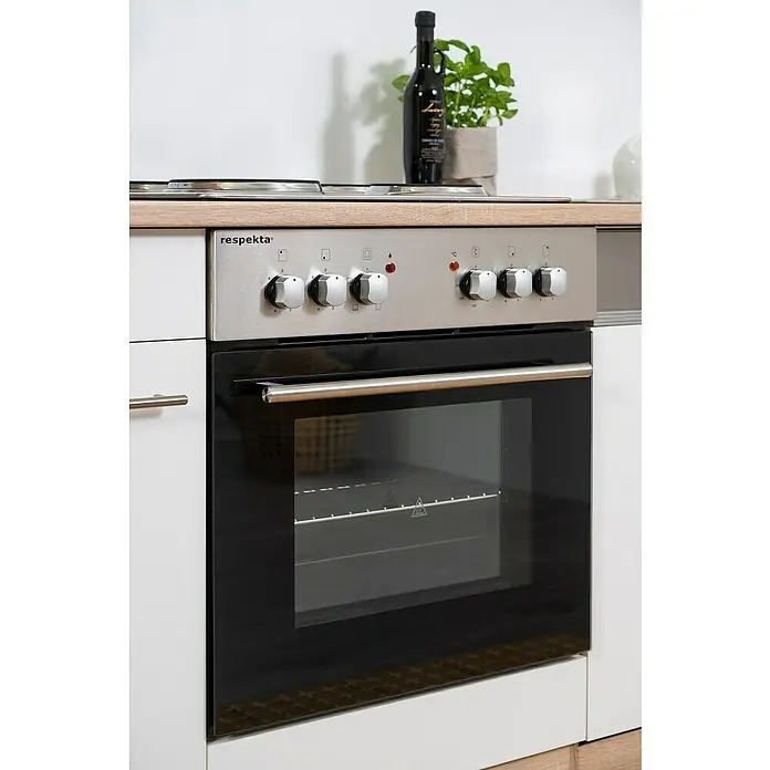 Respekta Singleküche Merle Typ 1 - Breite: 240 cm, Weiß, Mit Elektrogeräten, Volumen Backofen: 60 l - Nahaufnahme eines Respekta-Backofens mit Edelstahlblende und schwarzen Glasfront, eingebaut in eine moderne Küchenzeile mit hellen Holz- und weißen Elementen.