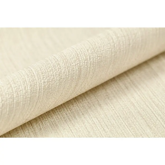 Rasch BARBARA Home Collection II Vliestapete - Beige, Uni, 10,05 x 0,53 m - Nahaufnahme einer Rolle strukturierten, cremefarbenen Stoffes, der eine weiche und einladende Textur für Polster oder Vorhänge bietet.