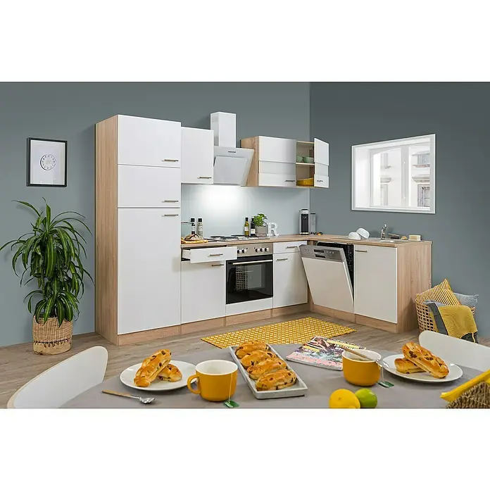 Respekta Winkelküche Merle - B x T: 280 x 172 cm, Weiß, Mit Elektrogeräten, Volumen Backofen: 60 l - Eine moderne Küche mit weißen und holzfarbenen Schränken, einem Geschirrspüler und einem Esstisch mit Gebäck und Tassen.