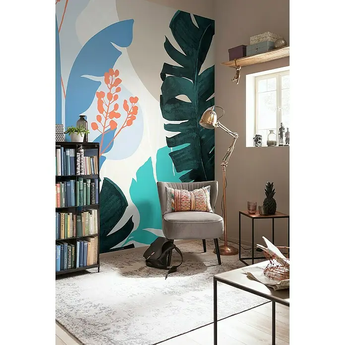 Komar Ink Fototapete Tropical Shapes - 6 -tlg., B x H: 300 x 280 cm, Vlies - Wohnzimmer mit Bücherregal, Sessel und Stehlampe, dekoriert mit Pflanzen-Wandbild und Accessoires für ein gemütliches Ambiente.