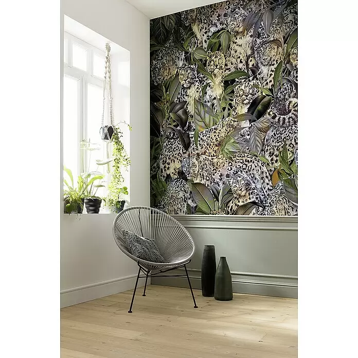 Komar Home Fototapete Wild Cats - B x H: 200 x 250 cm, Vlies - Tapete mit Schneeleoparden und tropischen Pflanzen, die eine Wand in einem modernen Wohnraum bedeckt.